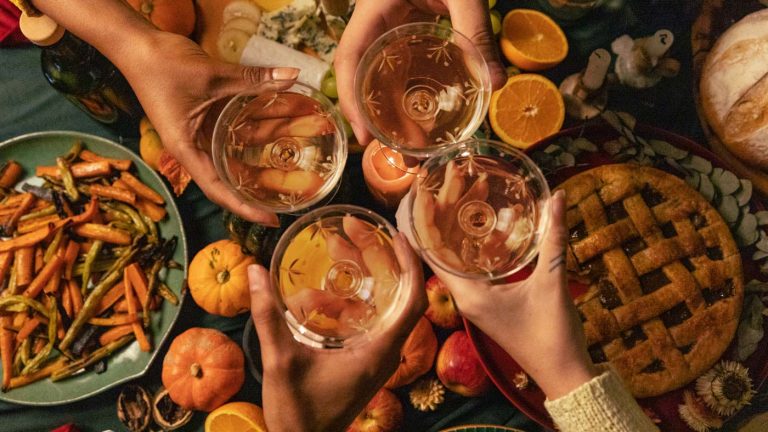 Clinking glasses at Thanksgiving dinner