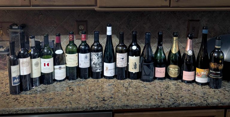 Various empty wine bottles at the end of a staff dinner