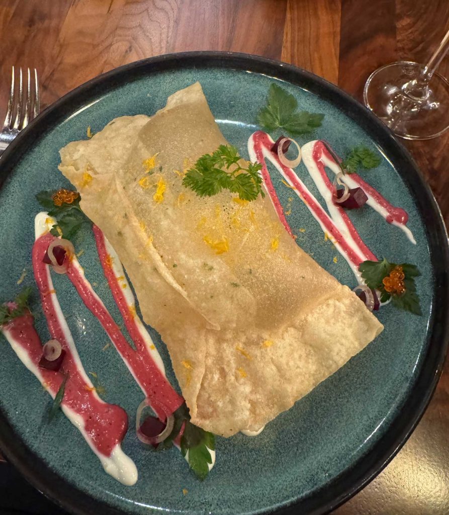 Crispy pastry with sauce and garnish on a plate