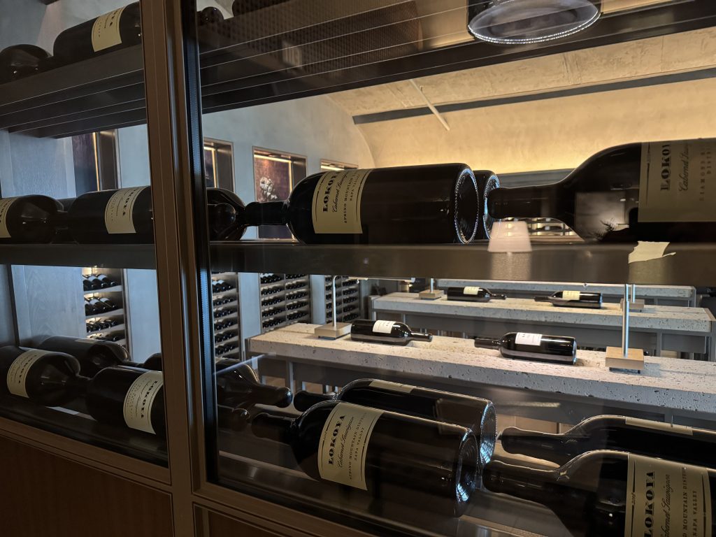 Lokoya wine bottles displayed in glass library case