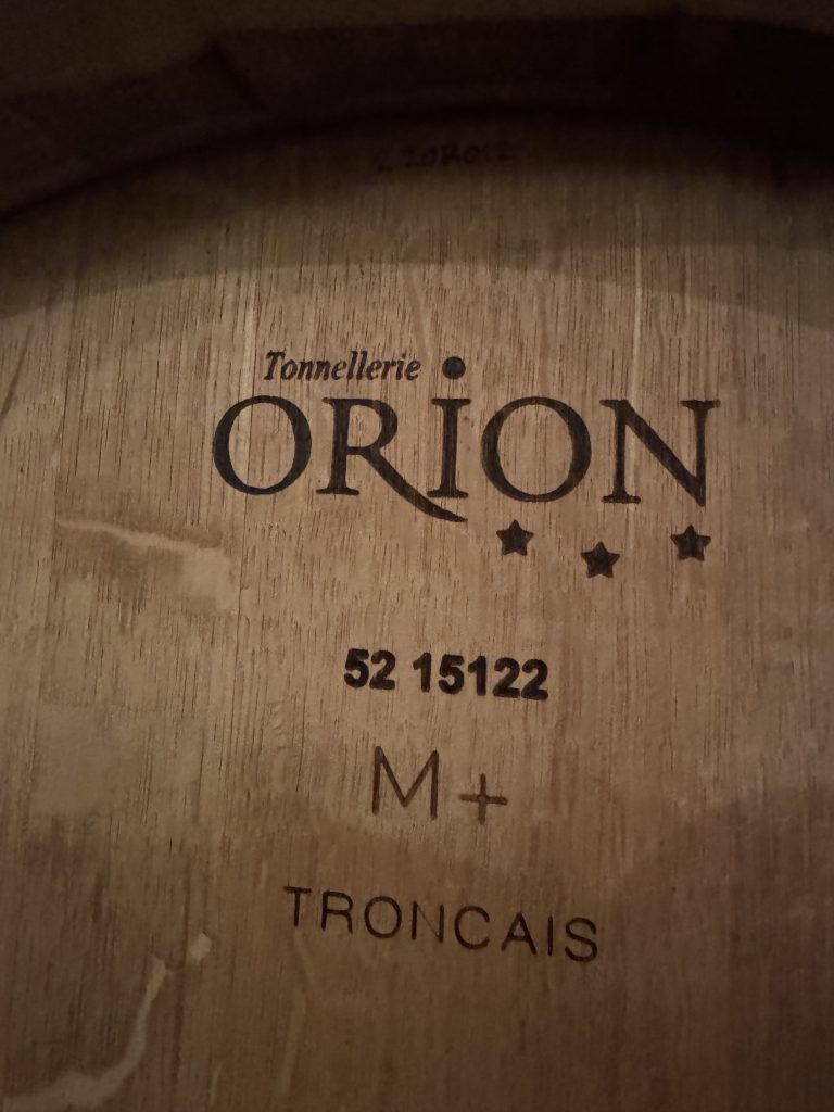 Close-up of a Tonnellerie Orion Tronçais oak barrel used for aging wine at OVID Winery on Pritchard Hill, Napa Valley