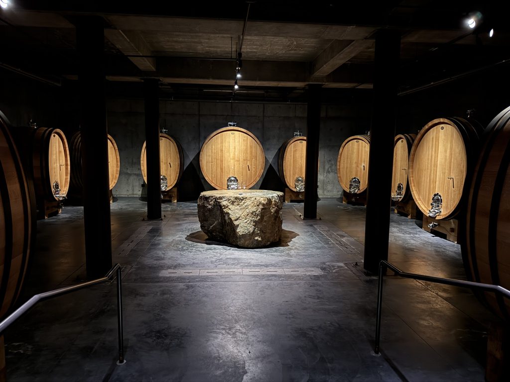 Wine barrels in a dim cellar at Promentory