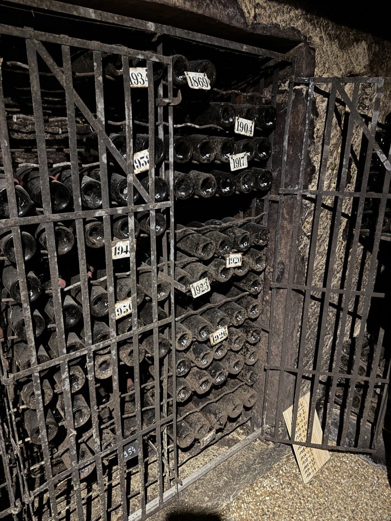 Historic stone spiral staircase descending into the wine cellar at Château Canon, Saint-Émilion
