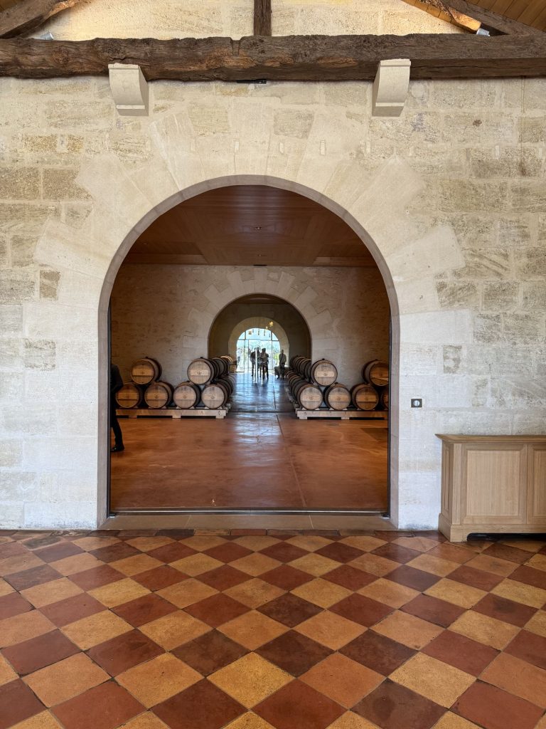 View into the barrel room at Château La Conseillante with diamond-tile floor, Pomerol, Bordeaux