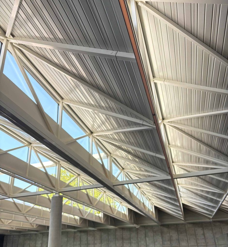 Looking up at the geometric diamond-pattern skylight and white structural roof of the new Lynch-Bages winery facility