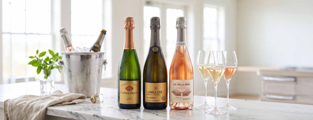 3 bottles of sparkling wine open on a kitchen counter