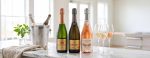 3 bottles of sparkling wine open on a kitchen counter